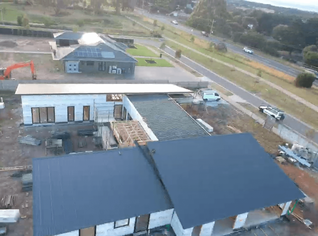 total roofing and cladding - aerial view slanted metal new roof